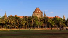 High Court: RERA-registered illegal buildings cannot be regularized; directs ED inquiry.